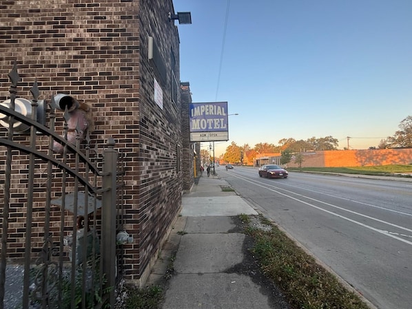 A brick building with a sign for Imperial Motel.
