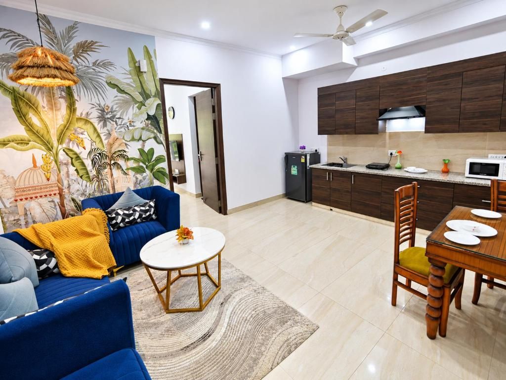 A living room with a sofa, coffee table, and a dining area with a table and chairs.