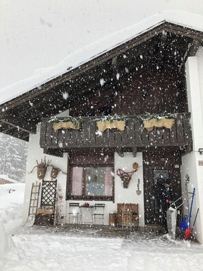 A two-story building with a snow-covered roof and a wooden facade. - New Listing (Pieve di Cadore)