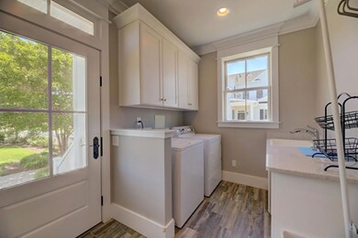 A laundry room with a washing machine, dryer, and a window.