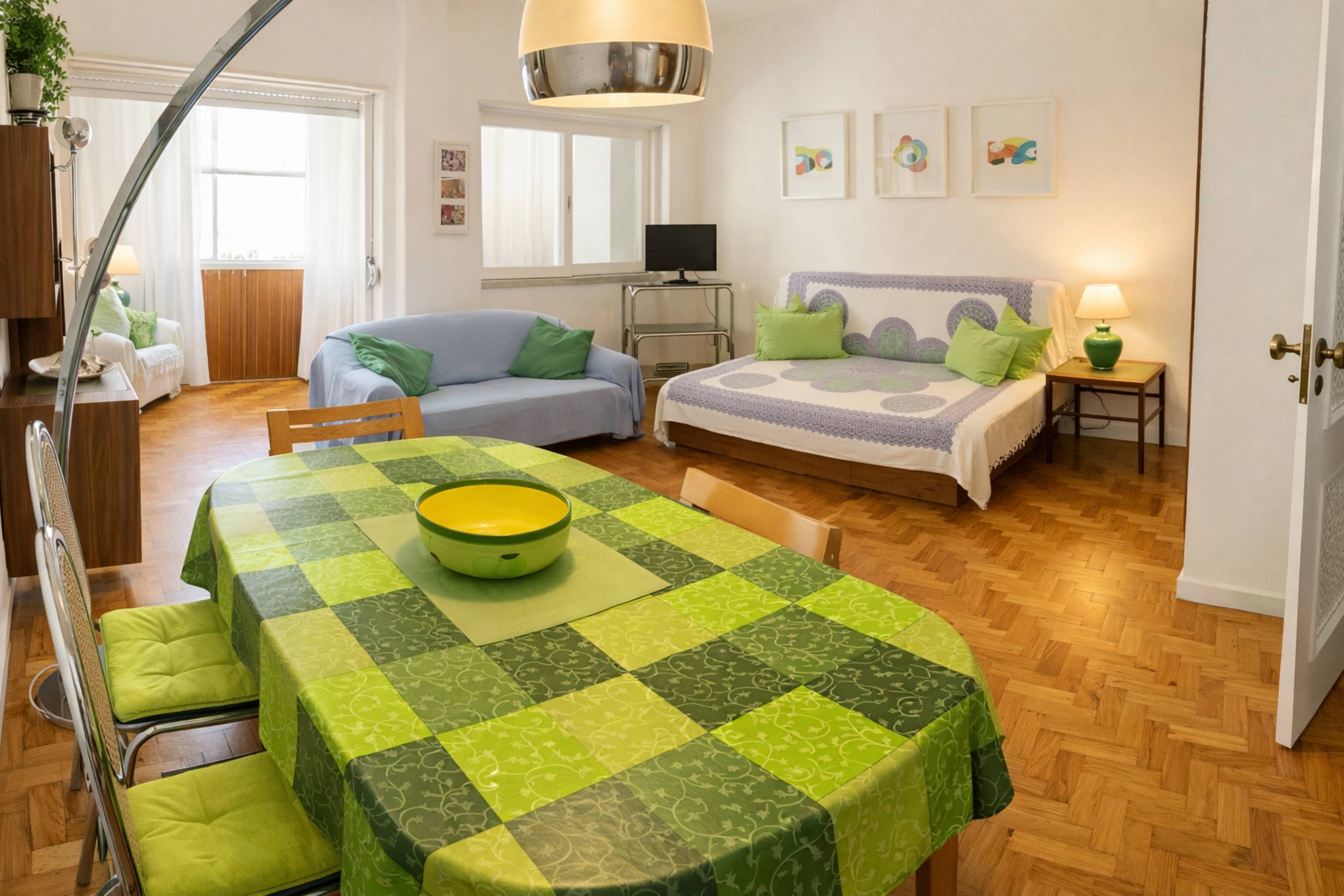 Una camera accogliente con un letto, un divano, un tavolo da pranzo e una televisione.