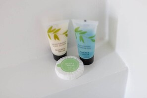 Three Mason & Miller toiletry items: a moisturizing body lotion, a refreshing shower gel, and a soap bar.