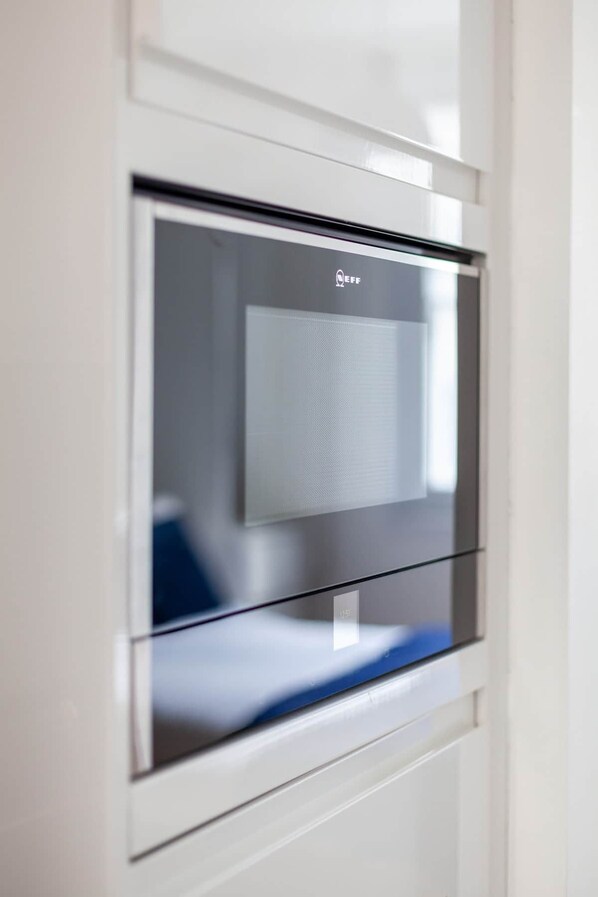 A modern kitchen with a built-in microwave oven.