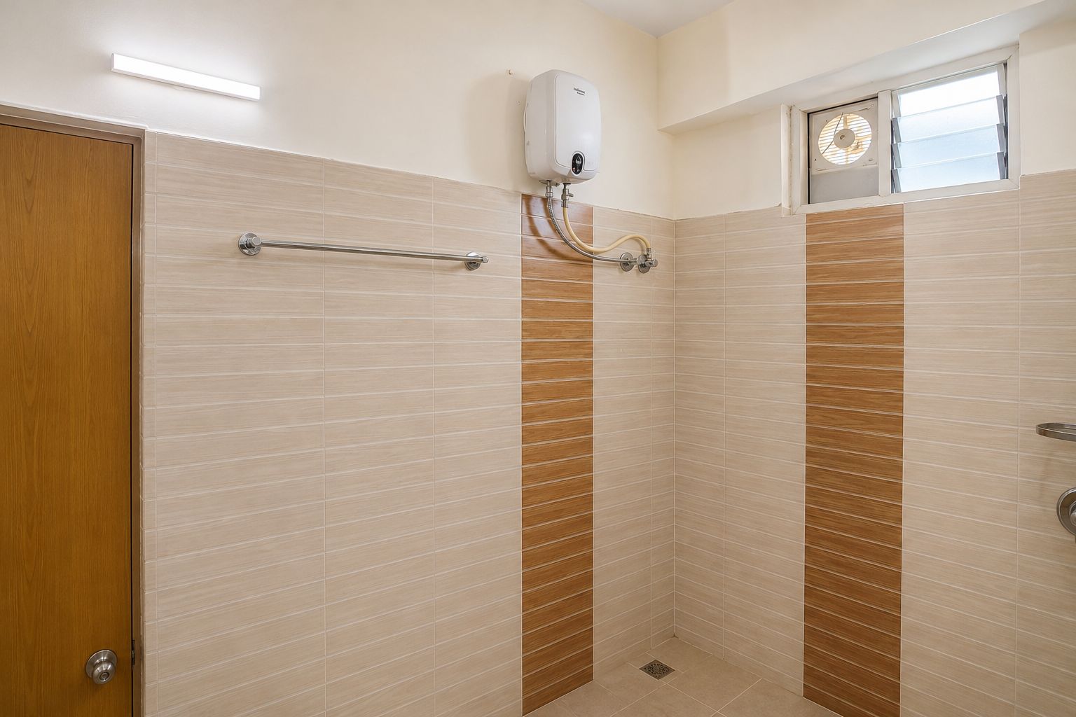 A bathroom with a shower, a towel rack, and a window.