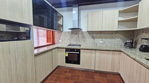 A compact kitchen with a built-in microwave, gas stove, and dishwasher. - Luxury 5 Bdrm Villa Walled City (Cartagena de Indias)