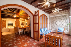 A cozy interior with a dining area, seating, and a decorative wall. - Luxury 5 Bdrm Villa Walled City (Cartagena de Indias)