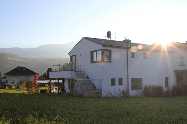 Une maison à deux étages dotée d’un balcon, d’une antenne parabolique et d’un escalier menant à l’étage supérieur.