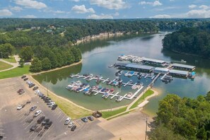 An aerial view of a marina with boats docked, a parking lot, and surrounding greenery. - Nolin Lake | Sleeps 10 | Private | Community Pool (Clarkson)