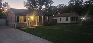 A single-story house with a front porch, a garage, and a well-maintained lawn. - Notre Dame Retreat I Hot Tub, Fire Pit & EV Charger (South Bend)
