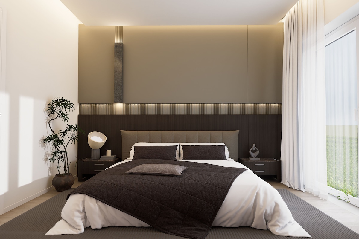 Un dormitorio moderno con cama, mesitas de noche, una lámpara y una planta en maceta.