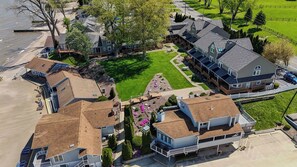 A residential area with houses, a lawn, and a beach. - Lighthouse Landing - 600 ft of Private Beach Views (Vermilion)