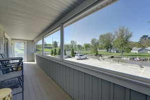 A covered outdoor area with a view of a parking lot and a body of water. - Lighthouse Landing - 600 ft of Private Beach Views (Vermilion)