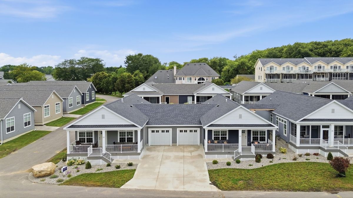A residential neighborhood with multiple two-story houses featuring front porches and attached garages.