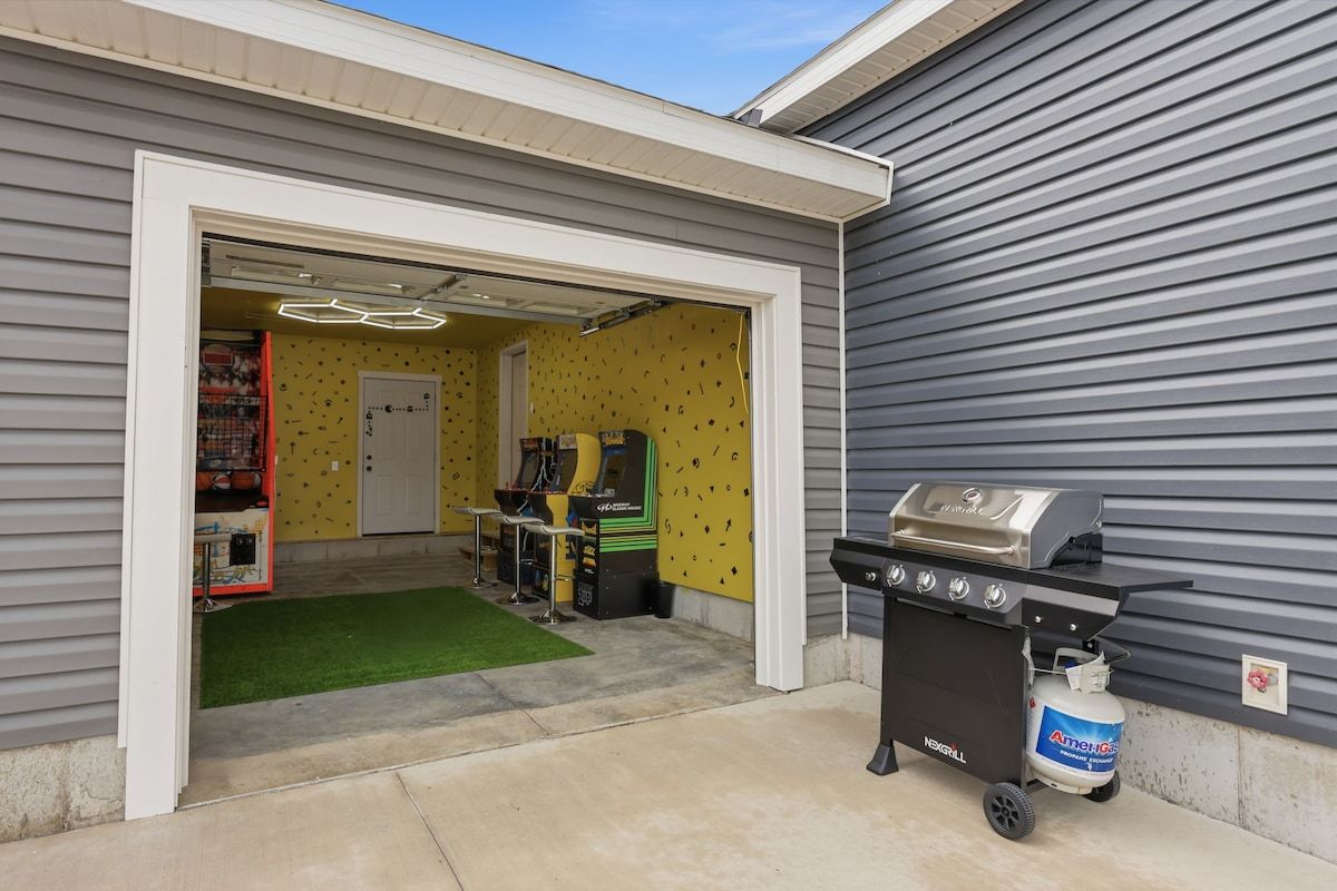 A garage with a grill and a toy arcade.