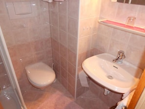 A bathroom with a toilet, a sink, and a shower area. - Garni Conturina - B&B (Santa Cristina Valgardena)