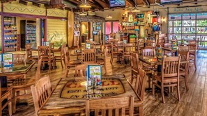 A restaurant with wooden furniture, a menu stand, and a sign reading "Wastin' Away Again...". - Margaritaville Vacation Club St. Thomas - Ocean View Studio Suite (Eastend)