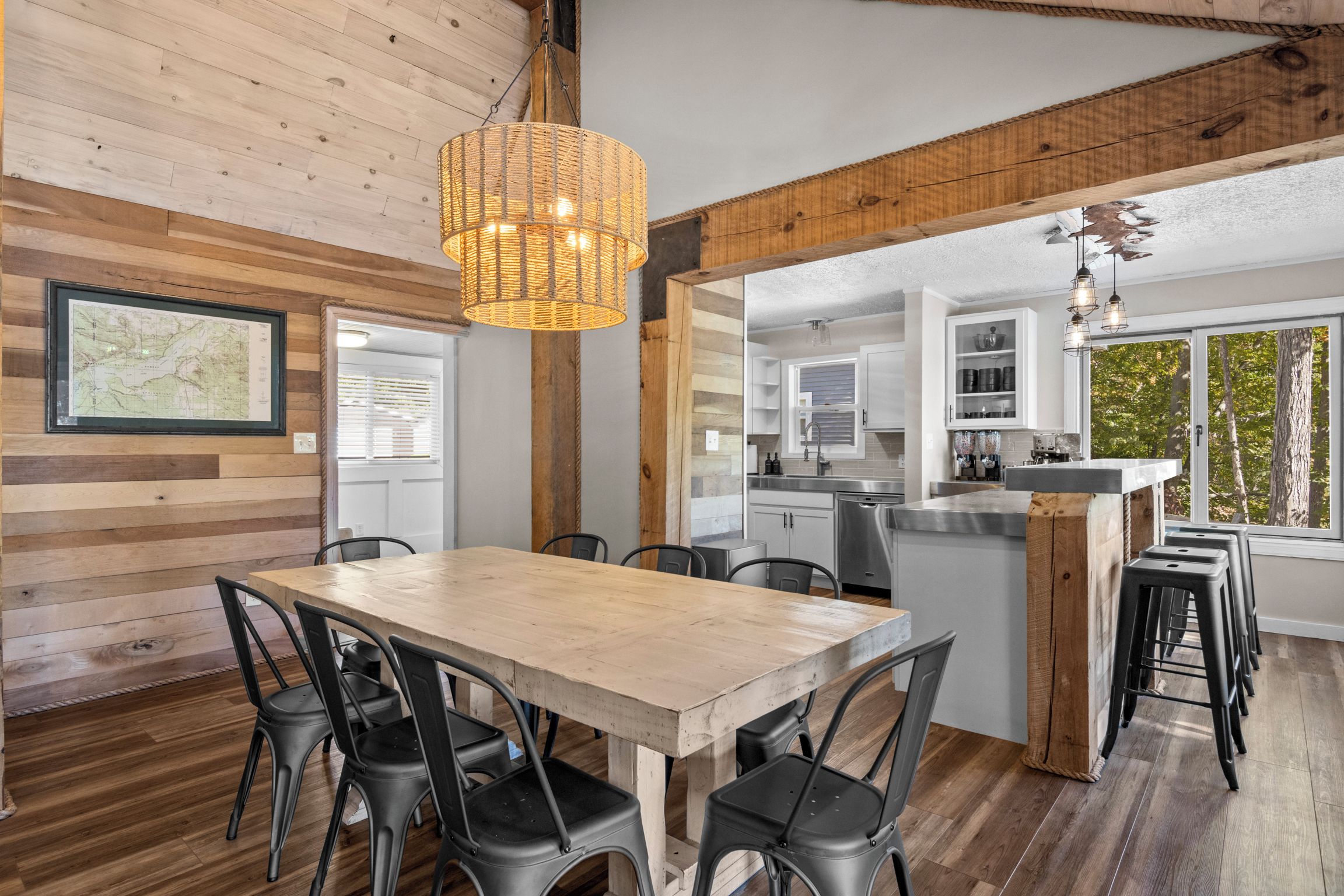 A modern kitchen with white cabinets, a stainless steel sink, and a large island.