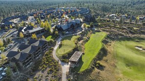Ett bostadsområde med flera hus, en golfbana och en parkeringsplats.