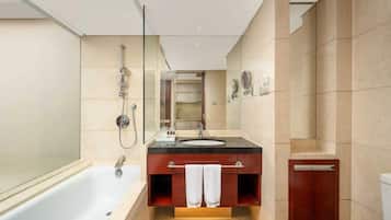 A modern bathroom with a bathtub, a sink, and a toilet.