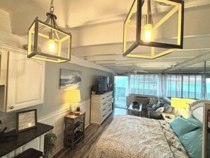 A bedroom with a bed, a dresser, a television, and a window with a view. - #213 Fontainebleau Terrace (Panama City Beach)
