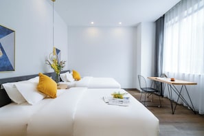 A modern hotel room with two beds, a dining table, and a chair. - xianwuhuahannuosijiudian (Xi'an)
