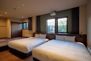 A hotel room with two beds, a large window, a projector, and a wardrobe. - Rakuten STAY VILLA Furano (Furanoshi)