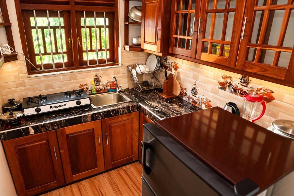 A kitchen with wooden cabinets, a gas stove, and a sink.