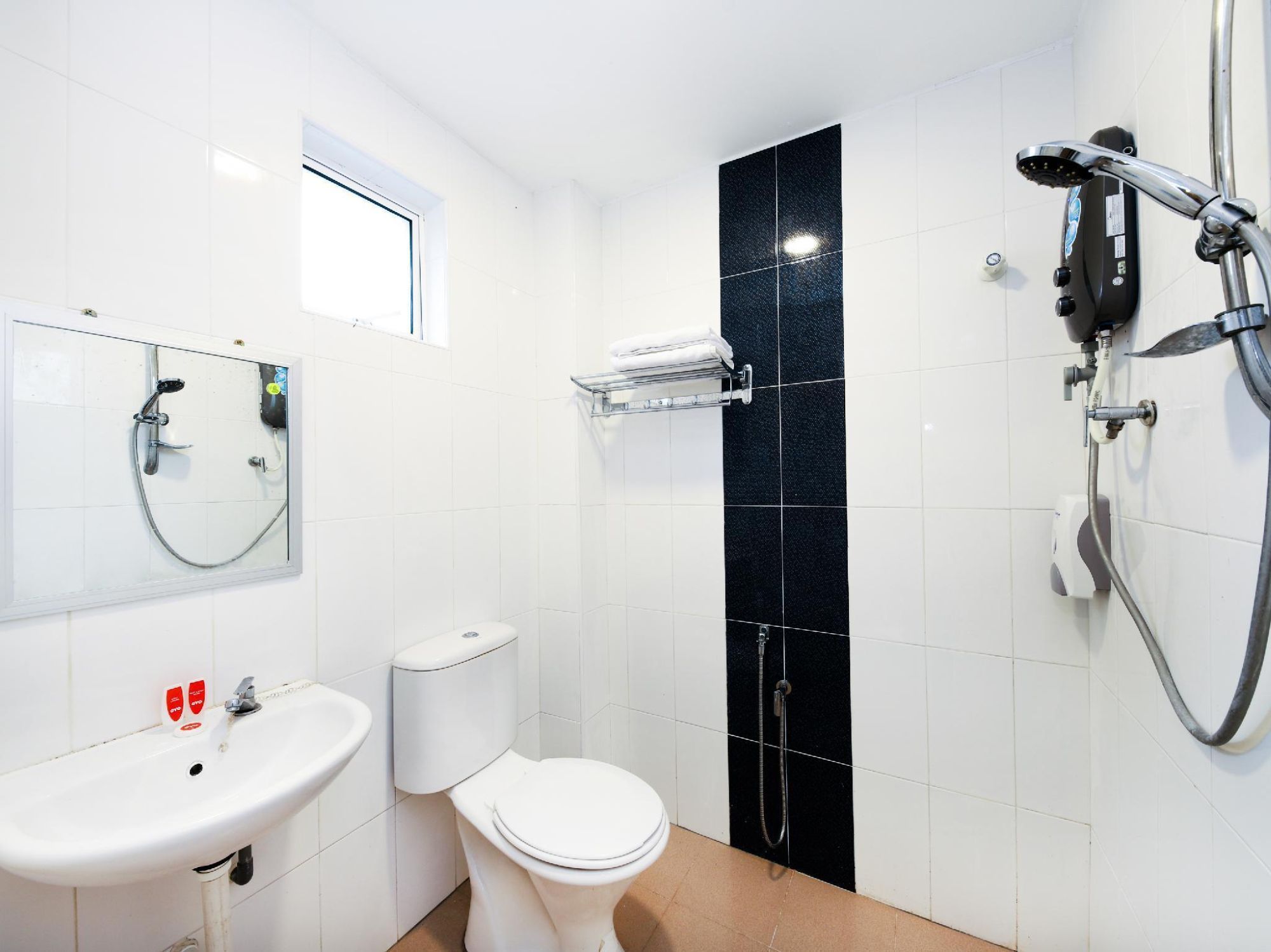 A modern bathroom with a toilet, sink, and shower.