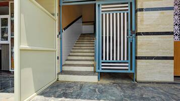 A staircase with a blue railing leading to an upper level.