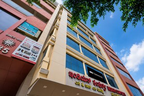 A multi-story building with a prominent sign for 'Indian Cuisine' and a large number '5' indicating a possible hotel or restaurant. - Hotel O INDIAN COMFORTS (Bangalore)