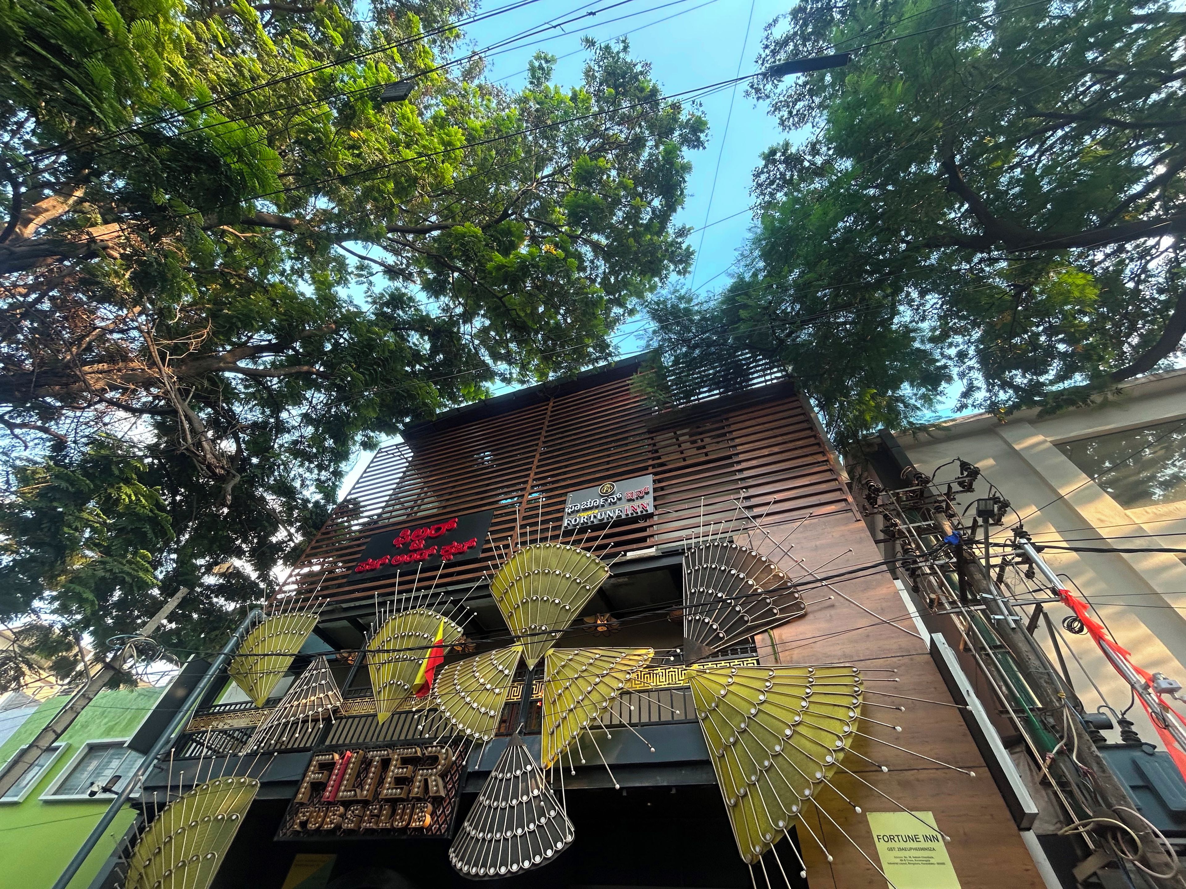A building with a sign for 'FLOER' and 'FORTUNE INN' with decorative fan-like structures.