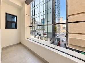A modern interior with a large window overlooking a city street. - Palette Capital Hotel (Abu Dhabi)