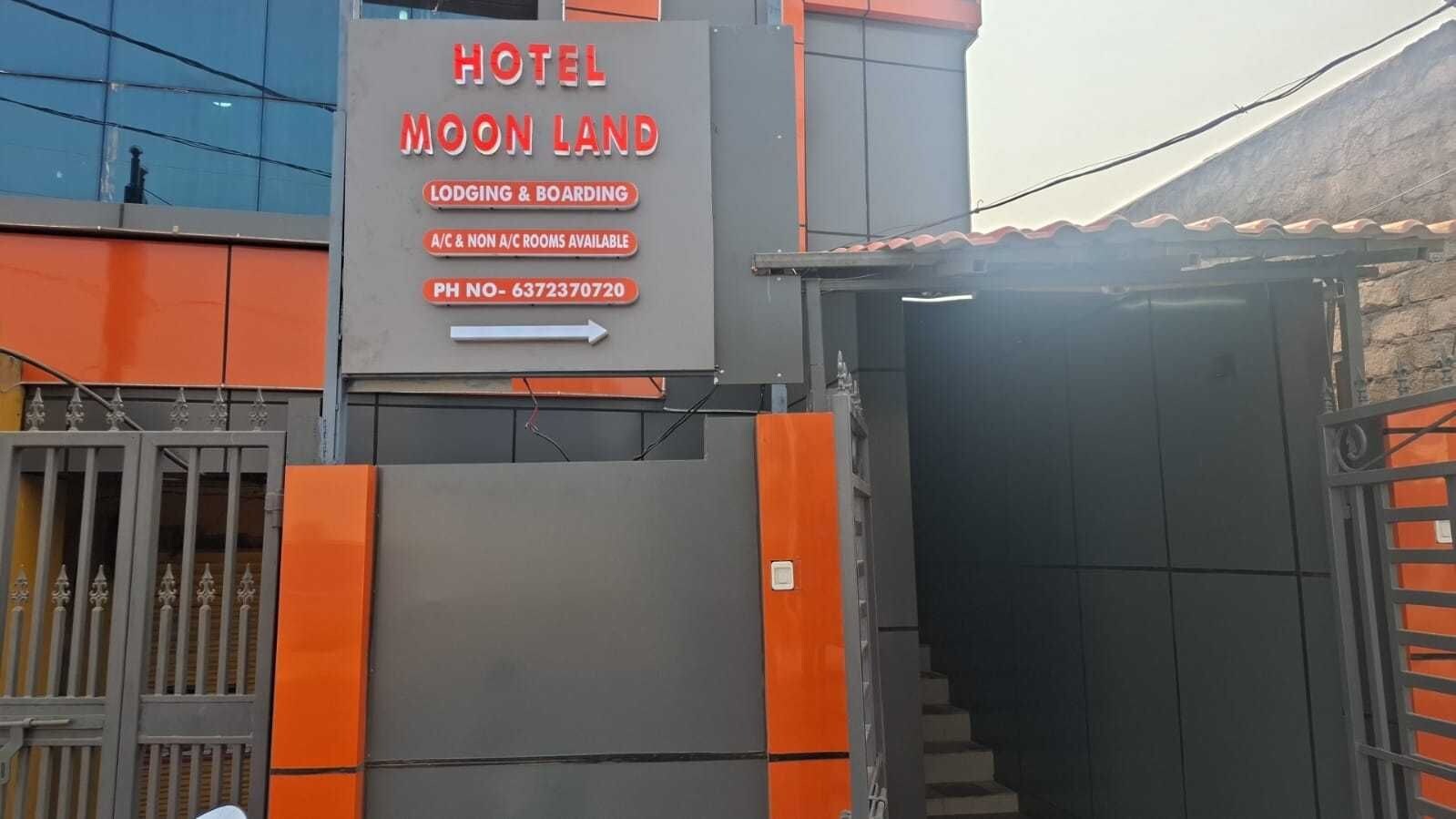 A hotel sign with the name 'MOON LAND' and services like lodging, boarding, and room types.