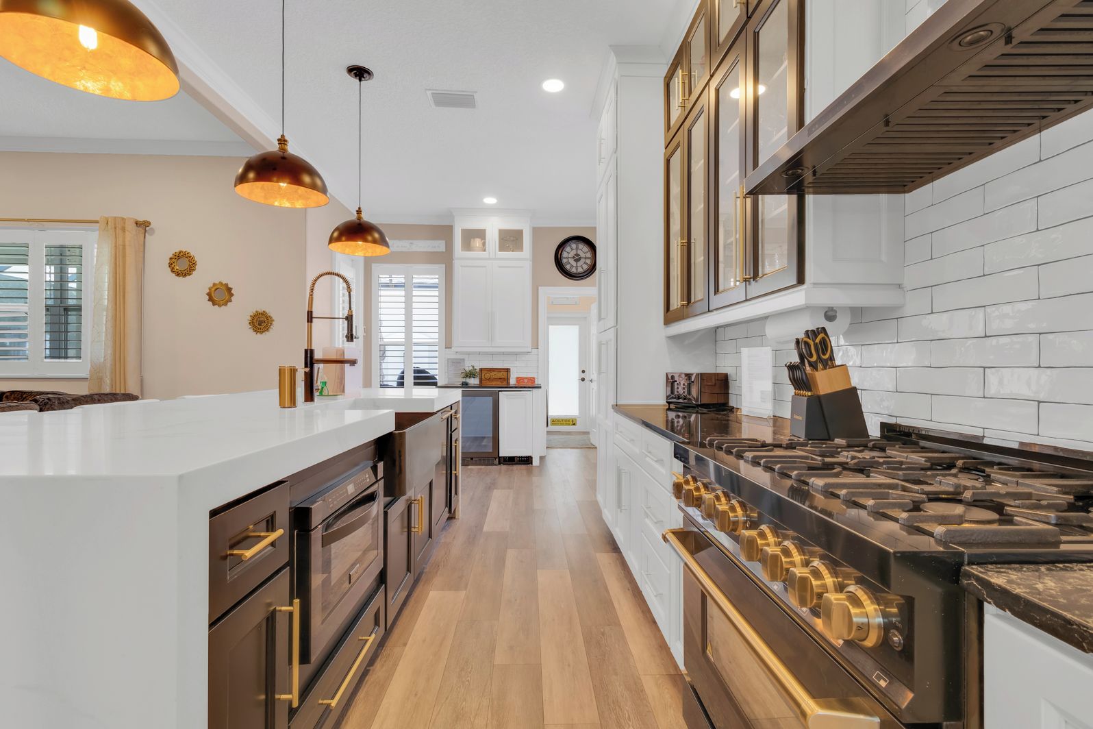 A modern kitchen with a central island, stainless steel appliances, and pendant lighting.