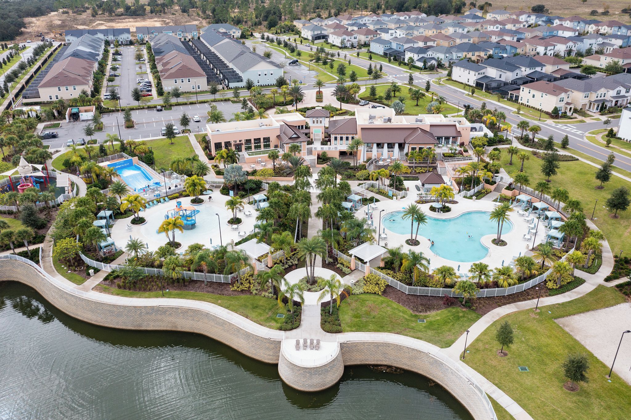 A residential area with a swimming pool, a children's play area, and a large building with multiple floors.