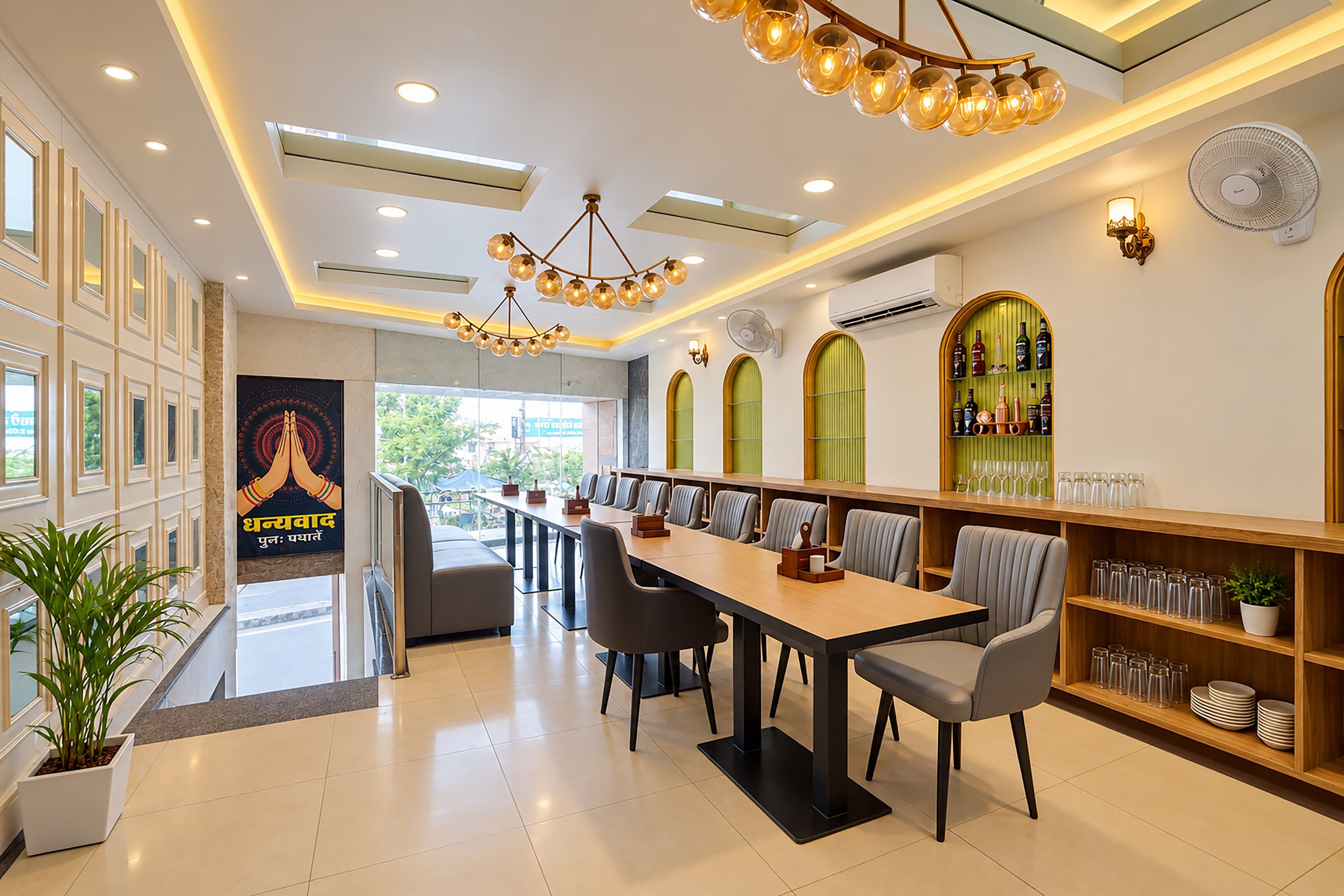 A modern dining area with a long table, chairs, and a decorative light fixture.