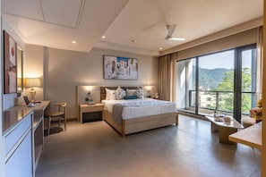 A modern hotel room with a large bed, bedside tables, a desk, and a view of the outdoors. - Resort De Coracao Tapovan Rishikesh (RISHIKESH)