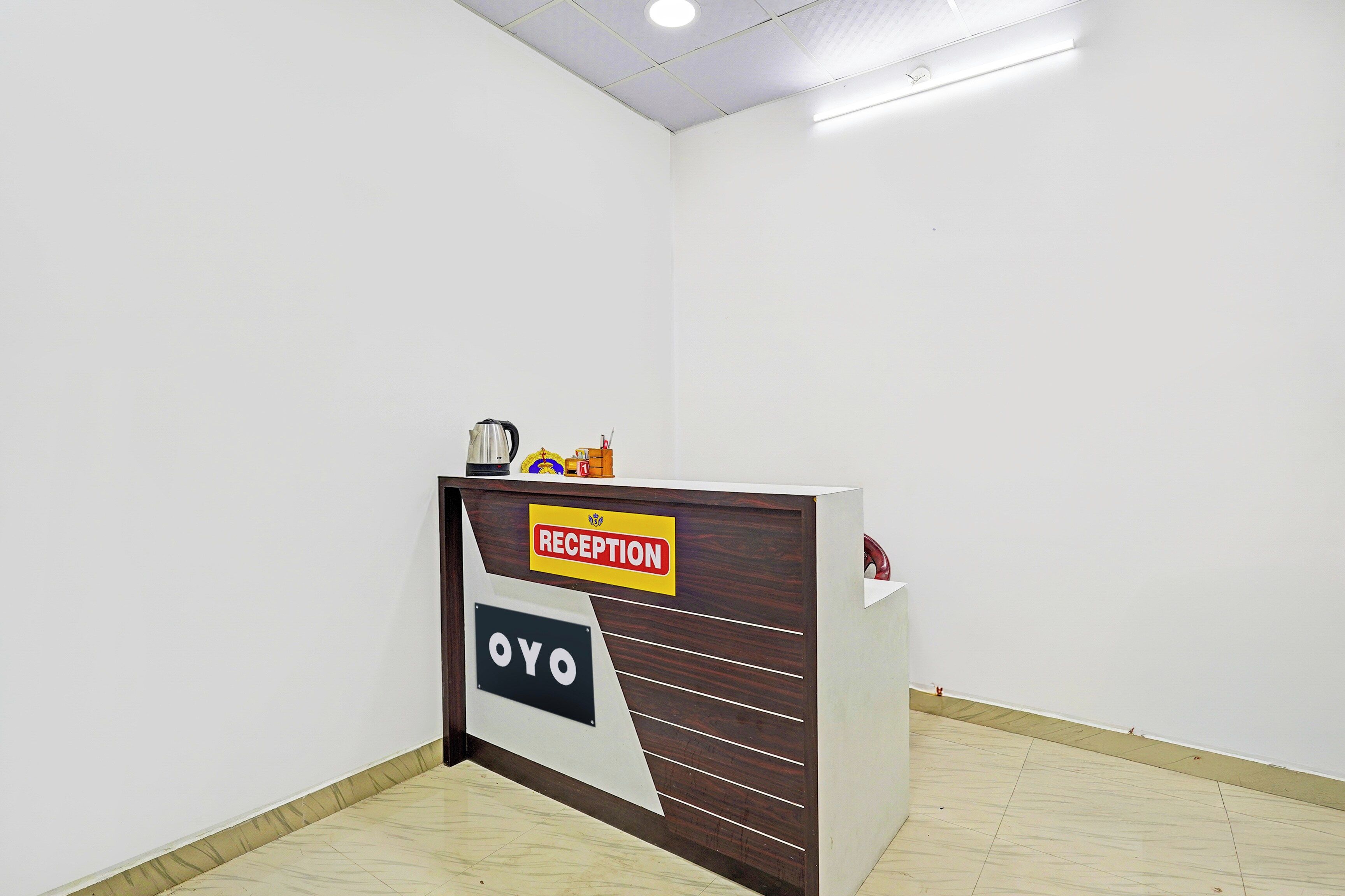 Un mostrador de recepción con un cartel que dice 'RECEPTION' y 'OYO'.
