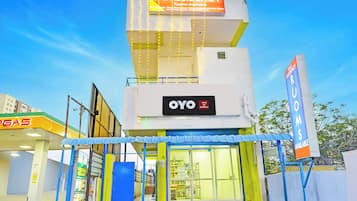 A hotel with a sign for 'SAI RESIDENCY' and 'OYO Hotel Sal Residency' indicating available rooms.