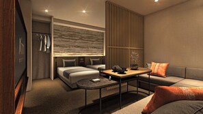 Ein modernes Hotelzimmer mit Bett, Sofa und einem kleinen Esstisch.