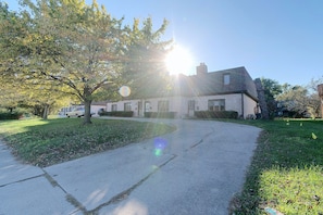 A residential street with a house, a driveway, and a tree. - 2 Mi to Campus! Convenient Townhome in Normal (Normal)