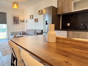Une cuisine moderne avec un plan de travail en bois et un vase blanc.