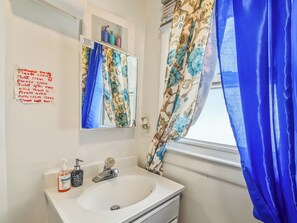 A bathroom with a sink, mirror, and a note on the wall. - Private Room&Bath in Owner-Occupied Home (Bridgeport)