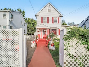 A two-story house with a red front porch, white picket fence, and a pathway leading to the entrance. - Private Room&Bath in Owner-Occupied Home (Bridgeport)