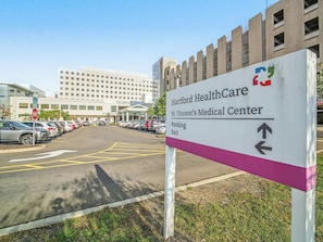 A parking sign for Hartford HealthCare St. Vincent's Medical Center with directional arrows for parking and exit. - Private Room&Bath in Owner-Occupied Home (Bridgeport)