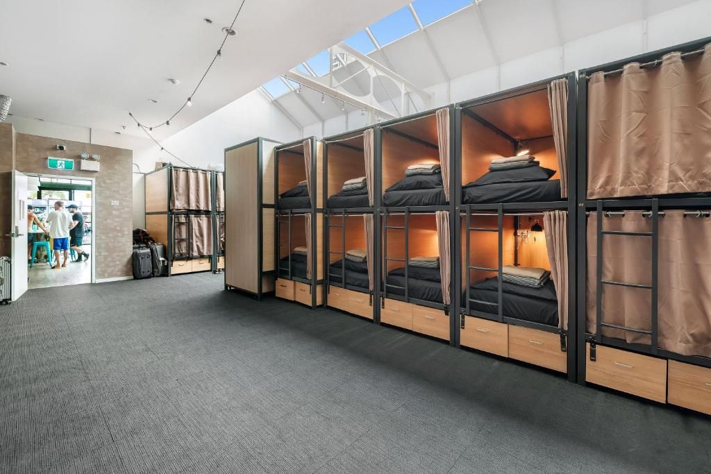 A hotel room with bunk beds, a wardrobe, and a skylight.