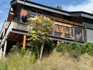 A modern two-story building with a balcony, large windows, and a satellite dish. - Holiday Home 'Ferienwohnung Lou' with Shared Garden, Balcony and Wi-Fi (Beverungen)