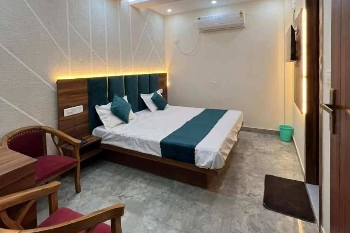 A modern bedroom with a bed, a desk, and a chair.