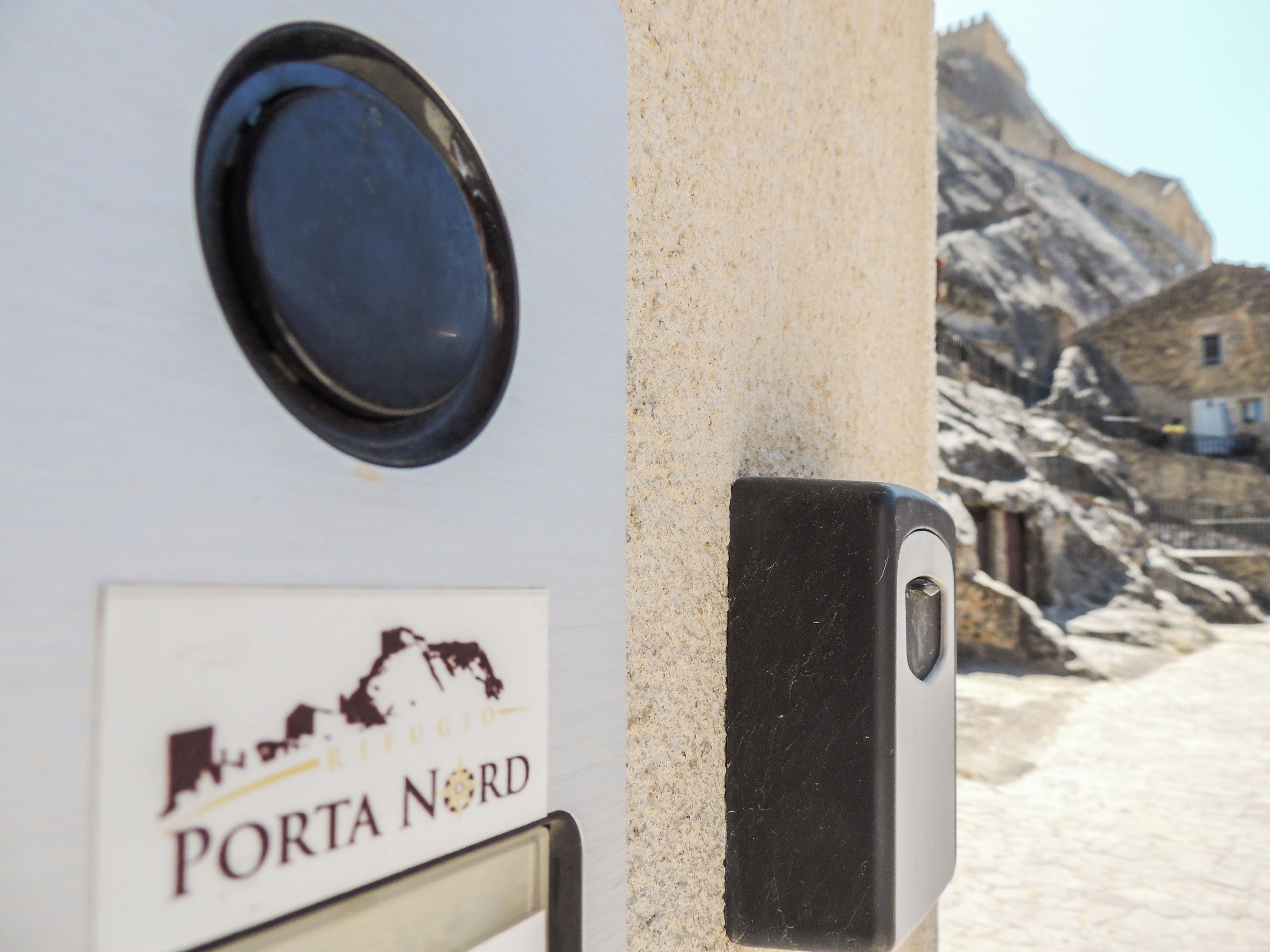 A sign with 'PORTA NORD' and a map outline.