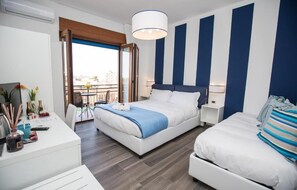 A hotel room with a bed, bedside tables, a desk, and a balcony with a view. - Sea Room Sorrento (Sorrento)